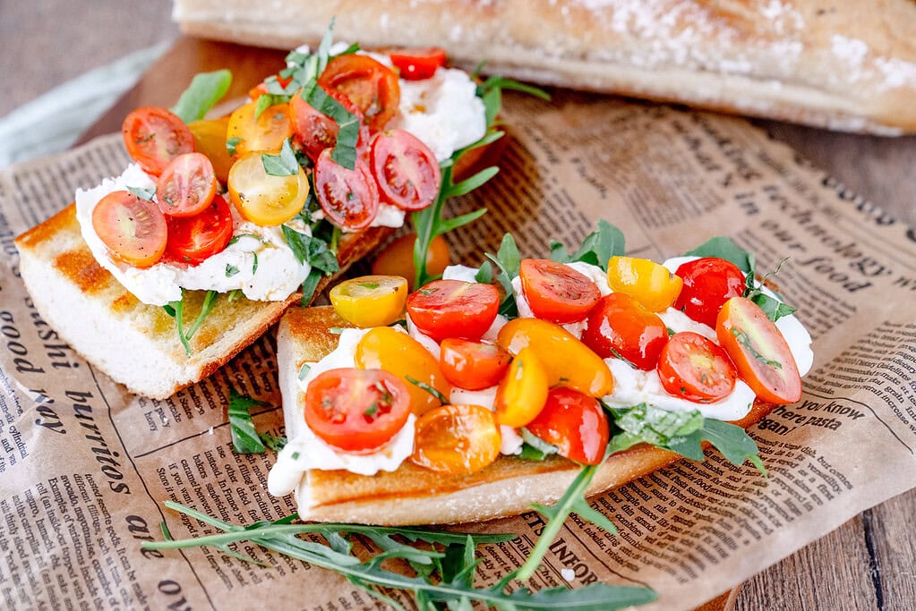 Burrata with baguette and cherry tomatoes and rocket