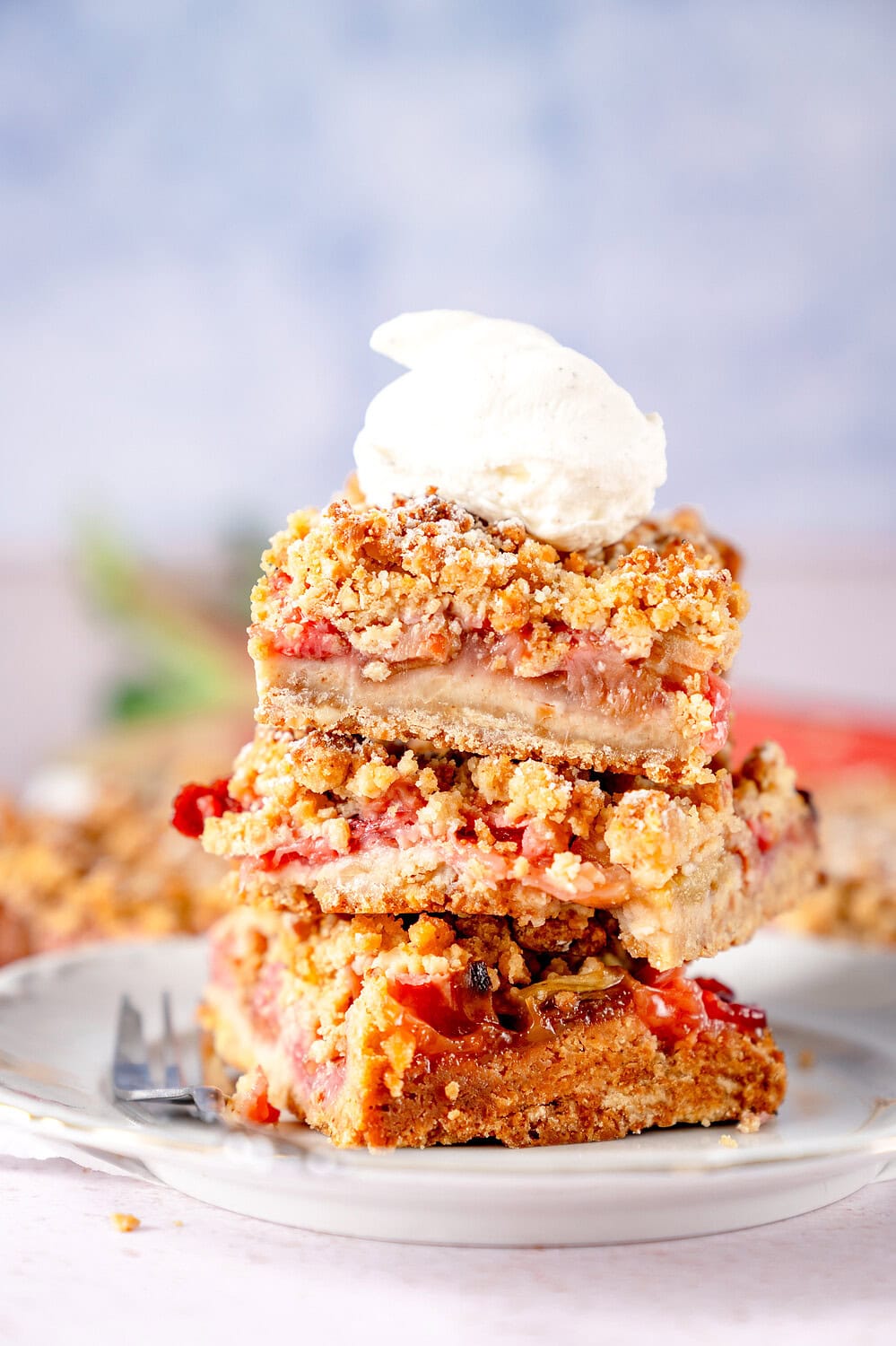 Rhubarb crumble cake with brown butter and a dollop of whipped cream on top