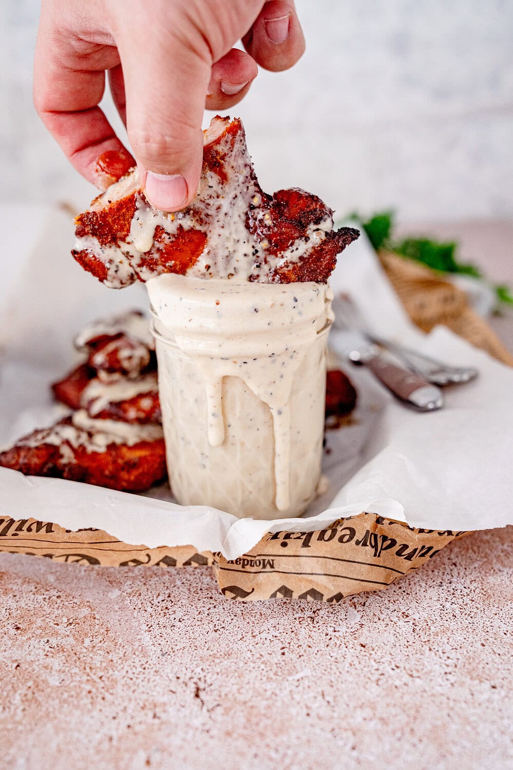 Chicken dipped in Alabama White Sauce