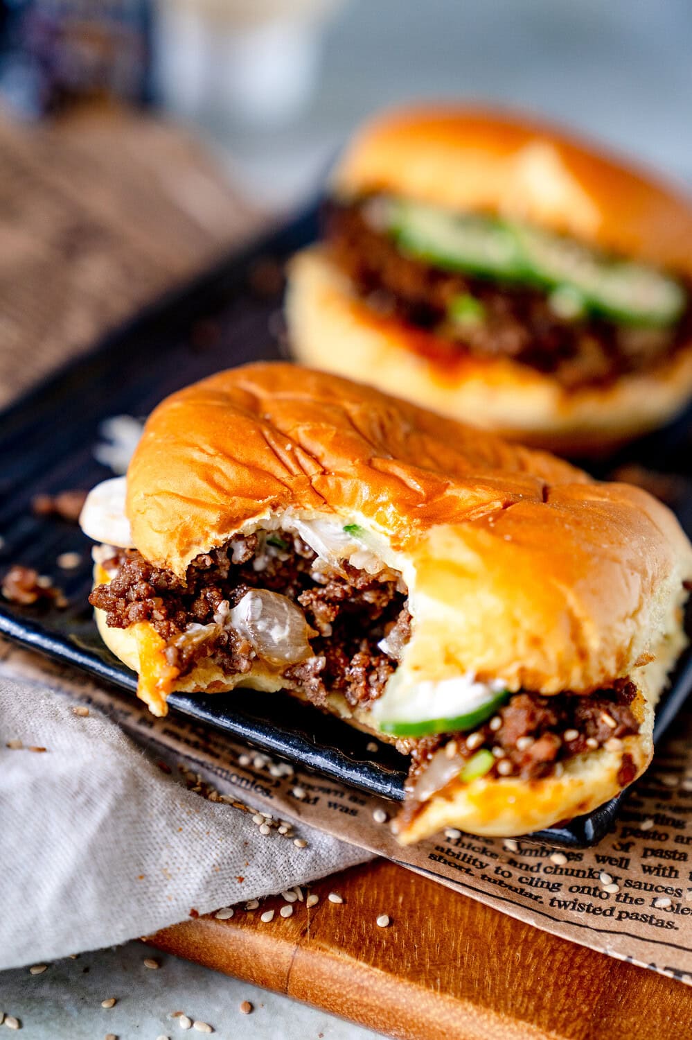 Half-eaten Sloppy Joe Burger with fresh cucumber and Kewpie mayonnaise