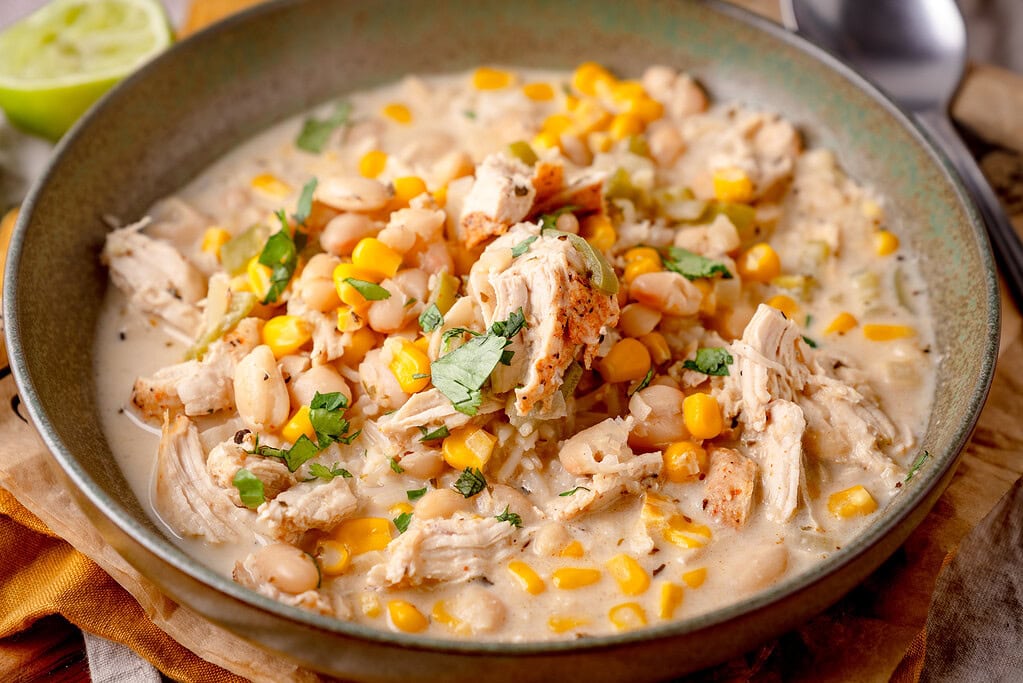 Delicious white chicken chili with corn, beans and fresh herbs in cream cheese sauce.