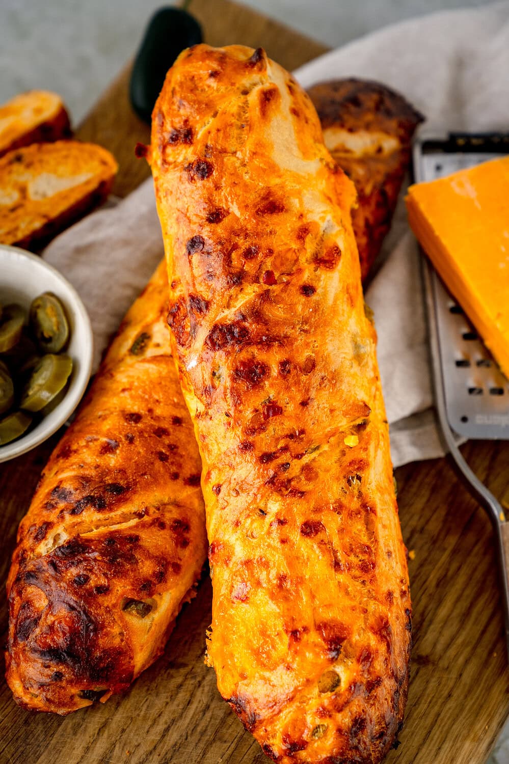 Chili cheese baguette close-up on a wooden board