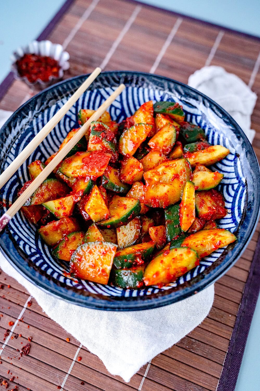 Oi Muchim or Korean cucumber salad in a blue bowl